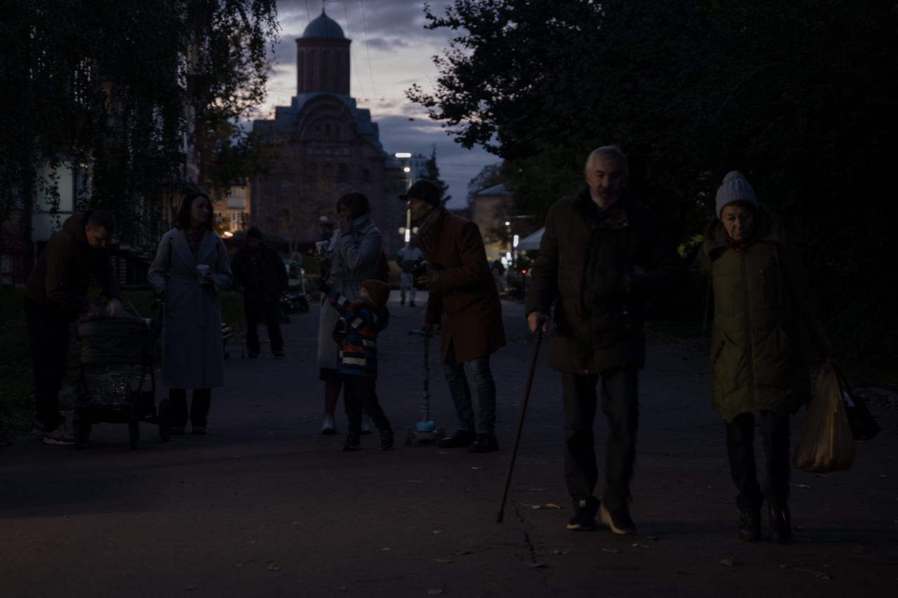 Residents gather in the streets despite the nightly strikes and power outages. Residents gather in the streets despite the nightly strikes and power outages.