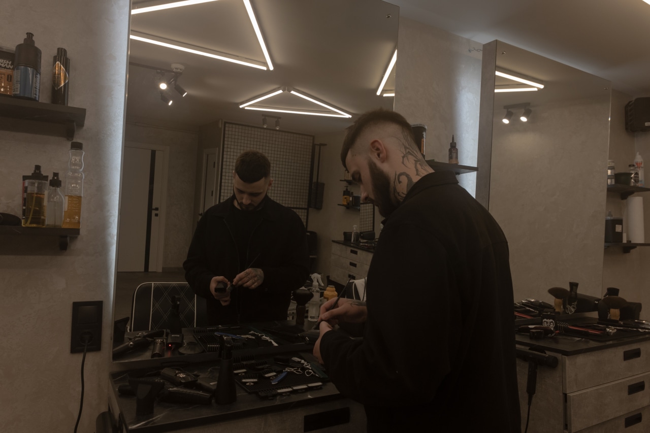Danylo Zaychenko relies on a generator when cutting hair inside the barbershop but sometimes see clients outside. Danylo Zaychenko relies on a generator when cutting hair inside the barbershop but sometimes see clients outside.