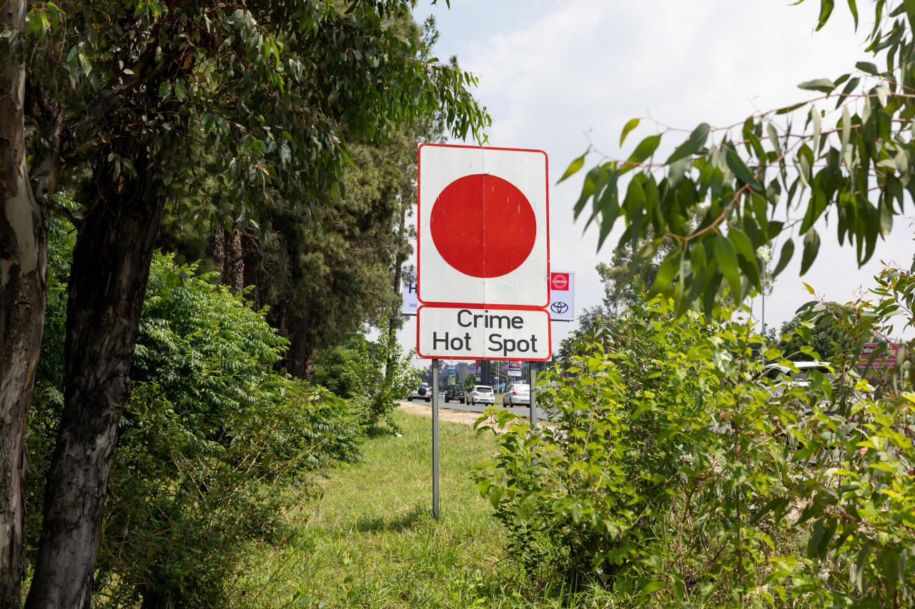 Signs warn people to be wary of crime at certain intersections.