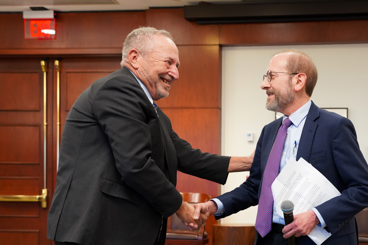 Larry Summers shakes hands with Harvard President Alan Garber at an event celebrating Summers’s 70th birthday.