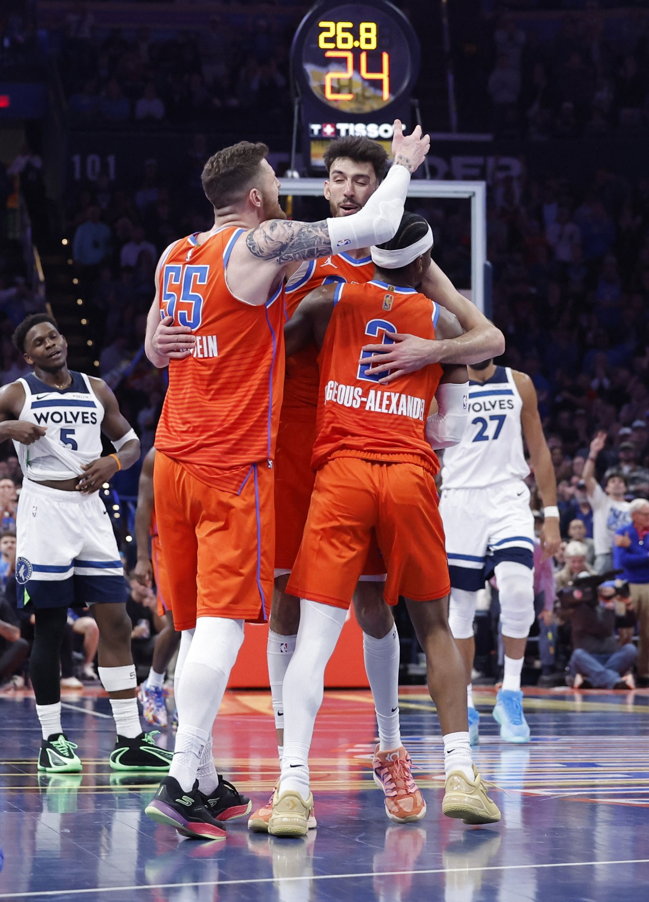 Thunder center Isaiah Hartenstein, Chet Holmgren and Gilgeous-Alexander celebrate after a play.