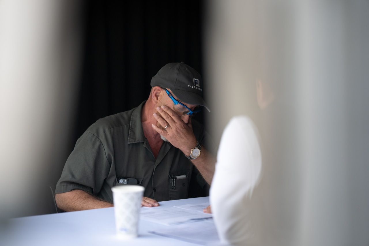 Fibrebond employees react as they are notified of their bonuses.