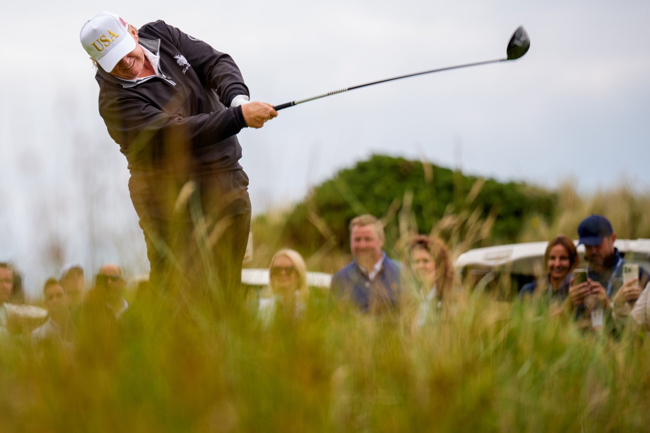 The president teeing off at a new 18-hole course near Aberdeen, Scotland, over the summer.