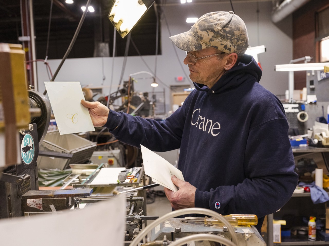 Auto engraver Neil Sprague works on a press that was built in 1910.