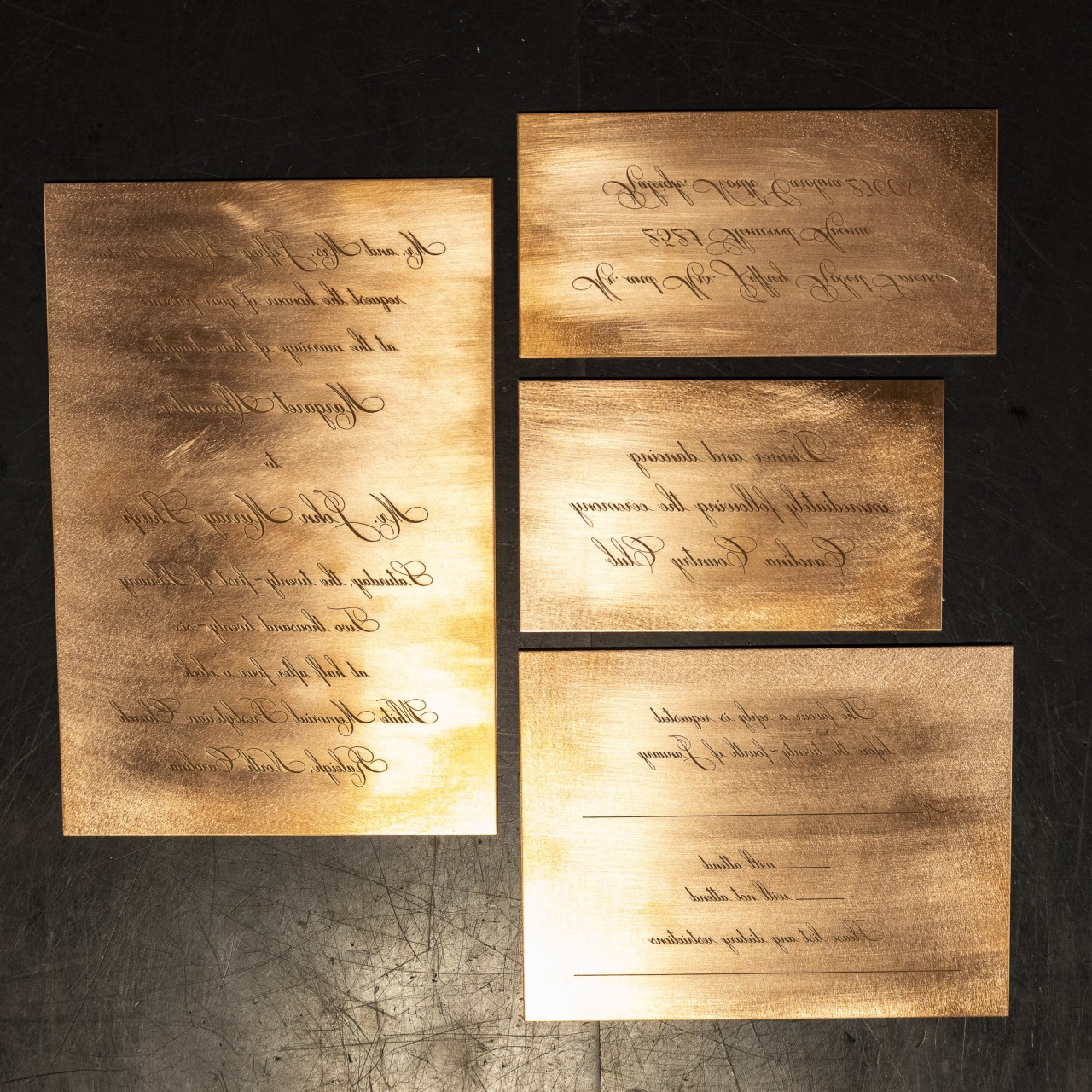 Copper engraving plates lie arranged, ready for printing at Crane Stationery.