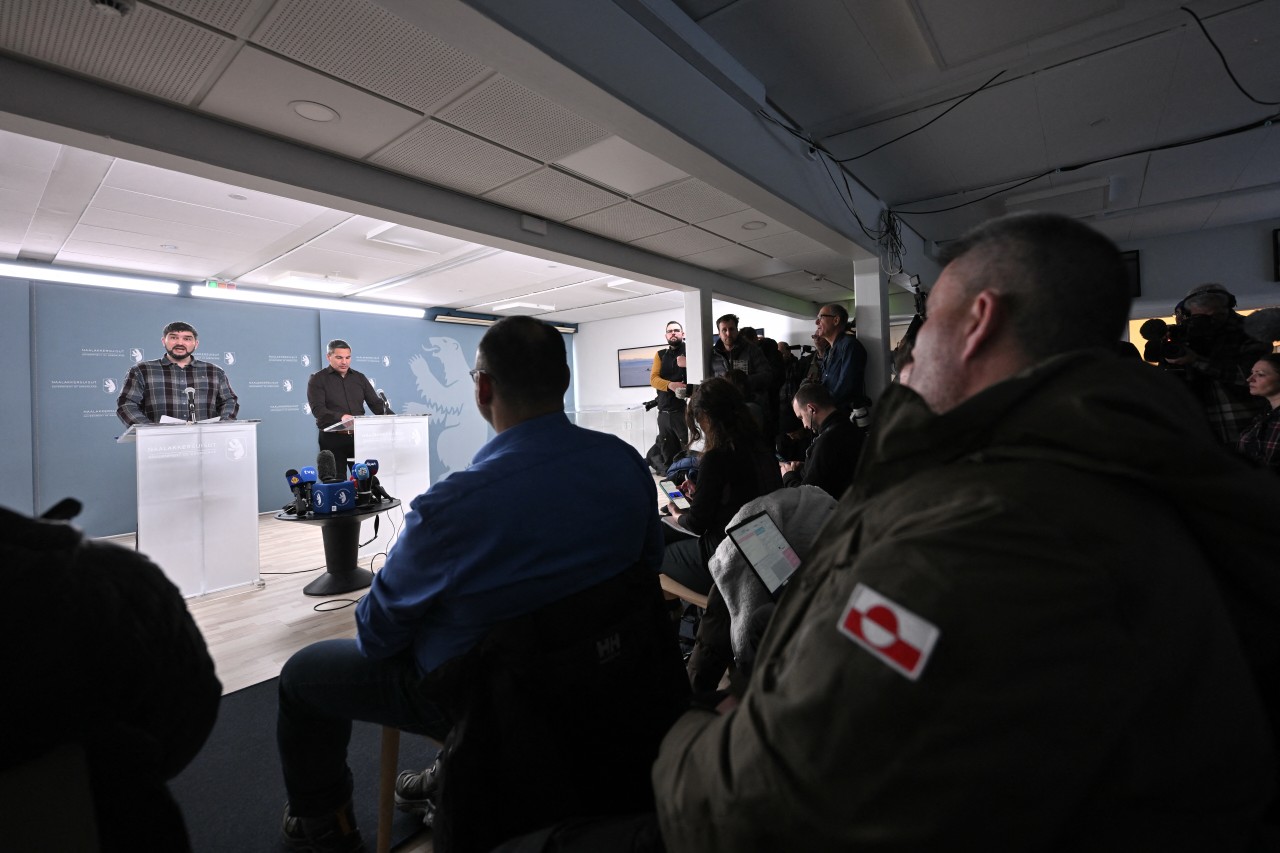 Officials Peter Borg, in plaid shirt, and Aqqaluaq B. Egede at a press conference in Nuuk, Greenland, on Wednesday. Jonathan Nackstrand/AFP/Getty Images