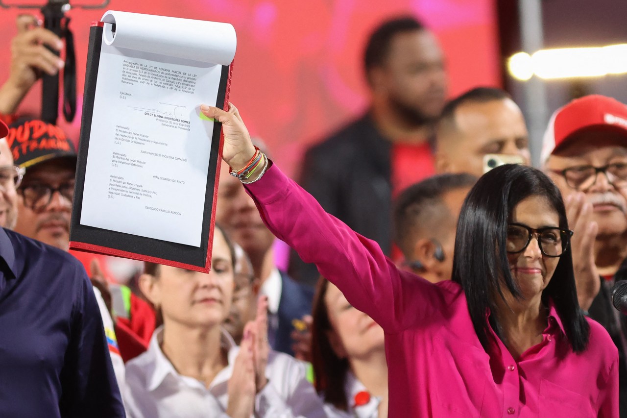 Interim leader Delcy Rodríguez with a copy of oil-industry legislation last month.