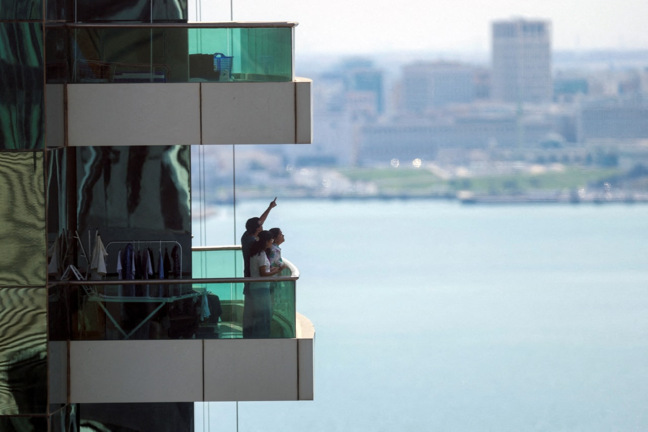 People watched from a balcony in Doha after Qatar said it had downed missiles targeting the country.