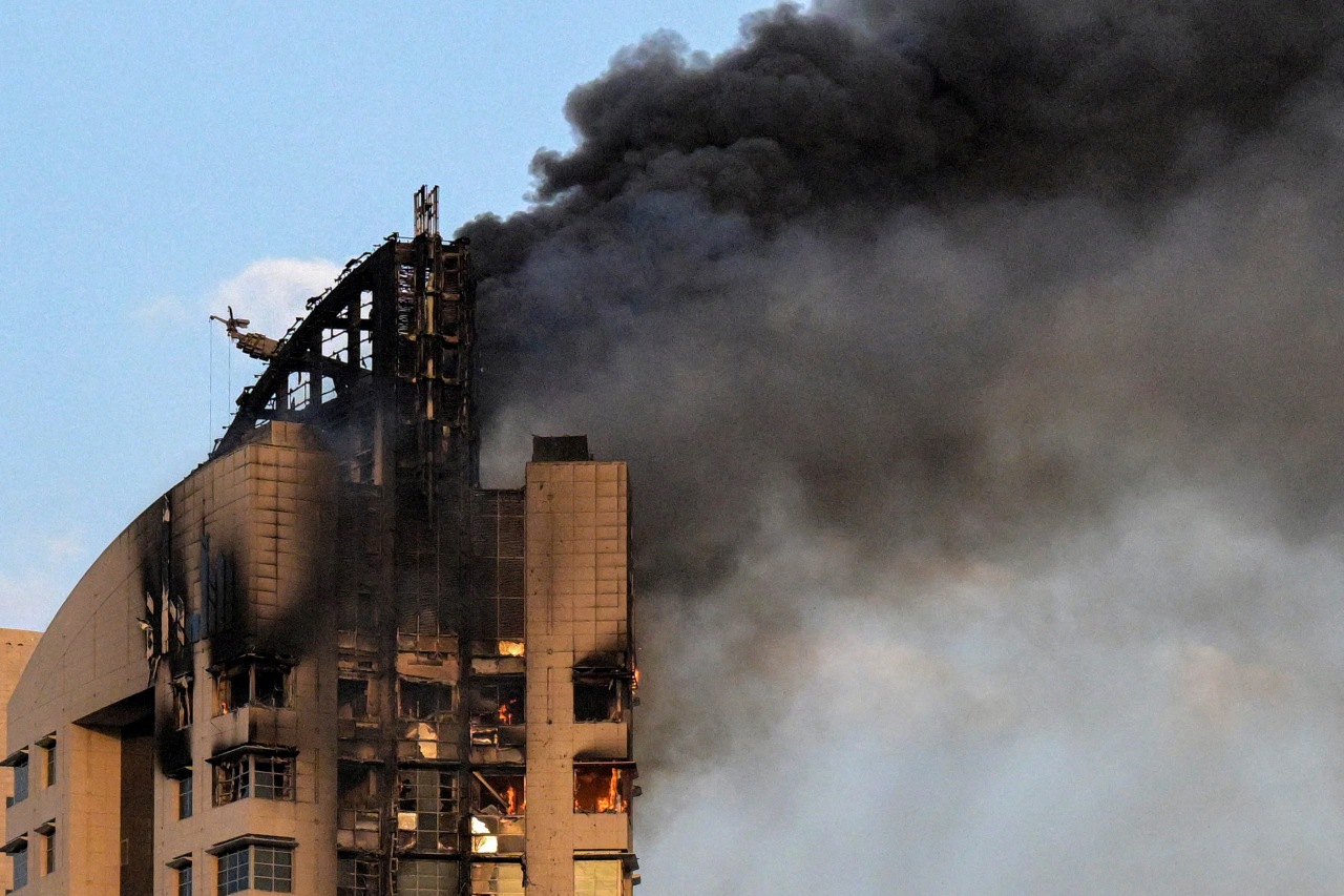 Smoke rises from a high-rise building following a drone attack Sunday in Kuwait City.