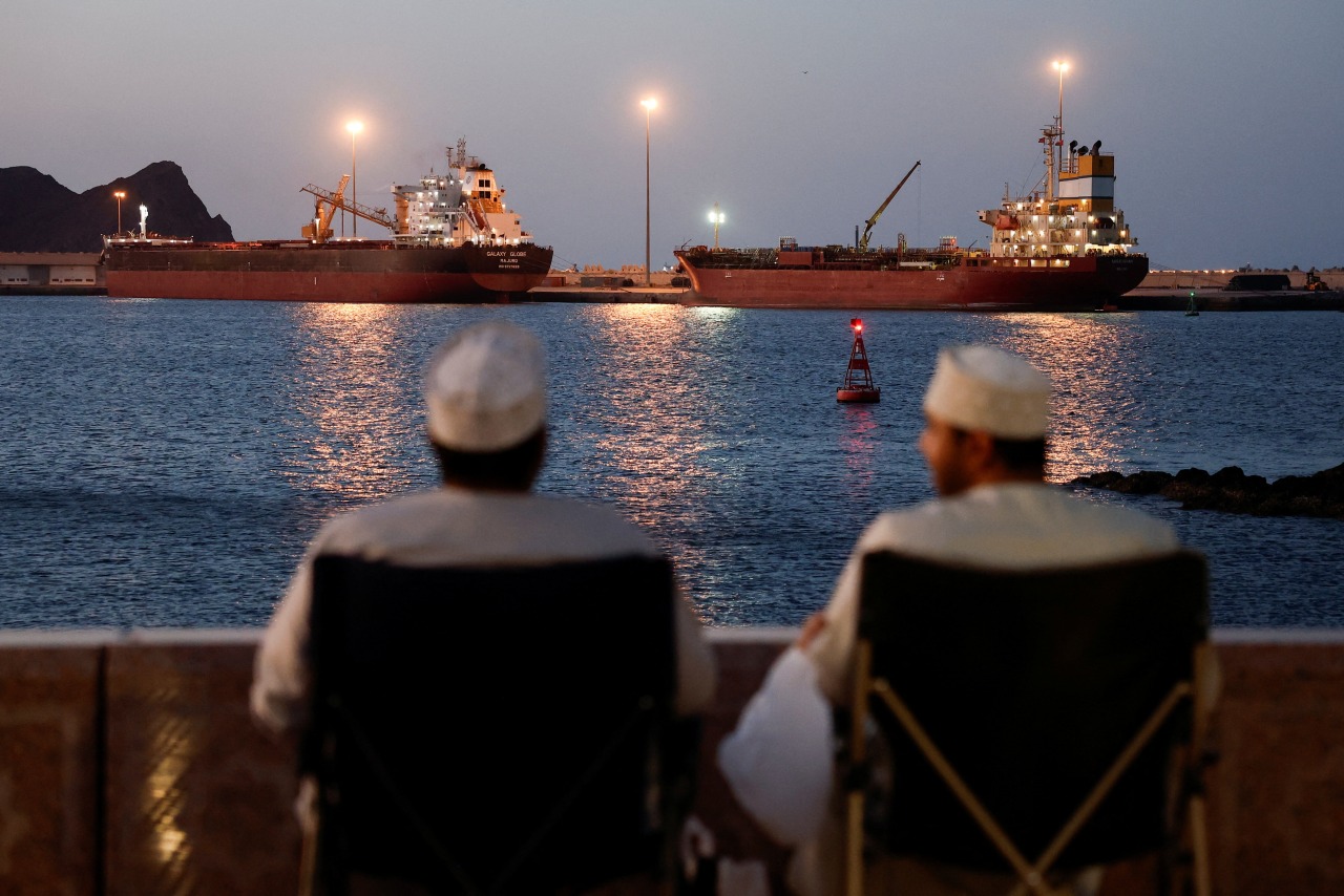 Ships sit anchored in Muscat, Oman, as they await safe passage through the Strait of Hormuz.
