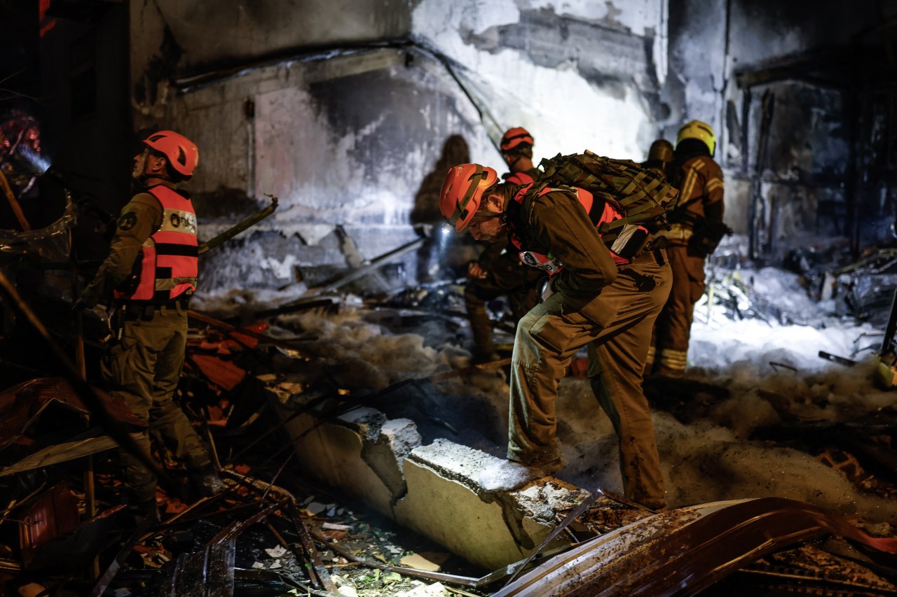 Firefighters and rescuers work at the site of a strike in the northern Israeli city of Nahariya on Monday. Hezbollah said it targeted the city.