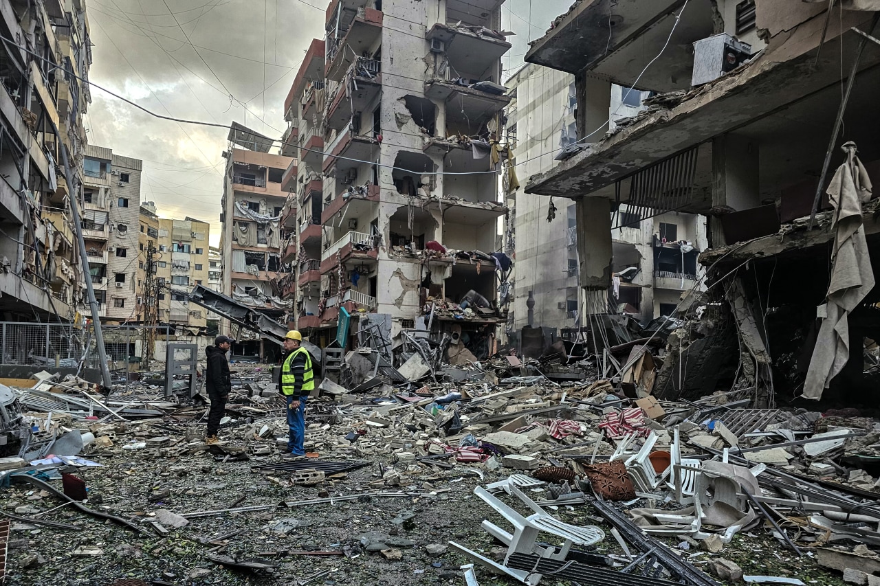 Men inspect a site of overnight Israeli airstrikes in the southern suburbs of Beirut on Monday.