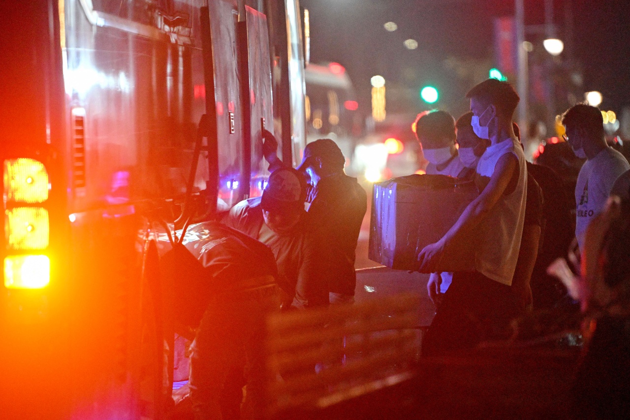 Workers carrying their belongings onto a bus in January as they leave an alleged scam compound in Sihanoukville, Cambodia, during a government crackdown on the operations.