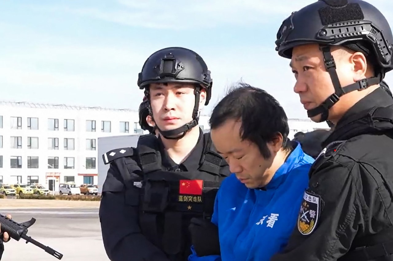 A frame grab from an undated video of accused scam operator Chen Zhi, center, in Beijing after his extradition from Cambodia, in footage released in January by China’s ministry of public security.