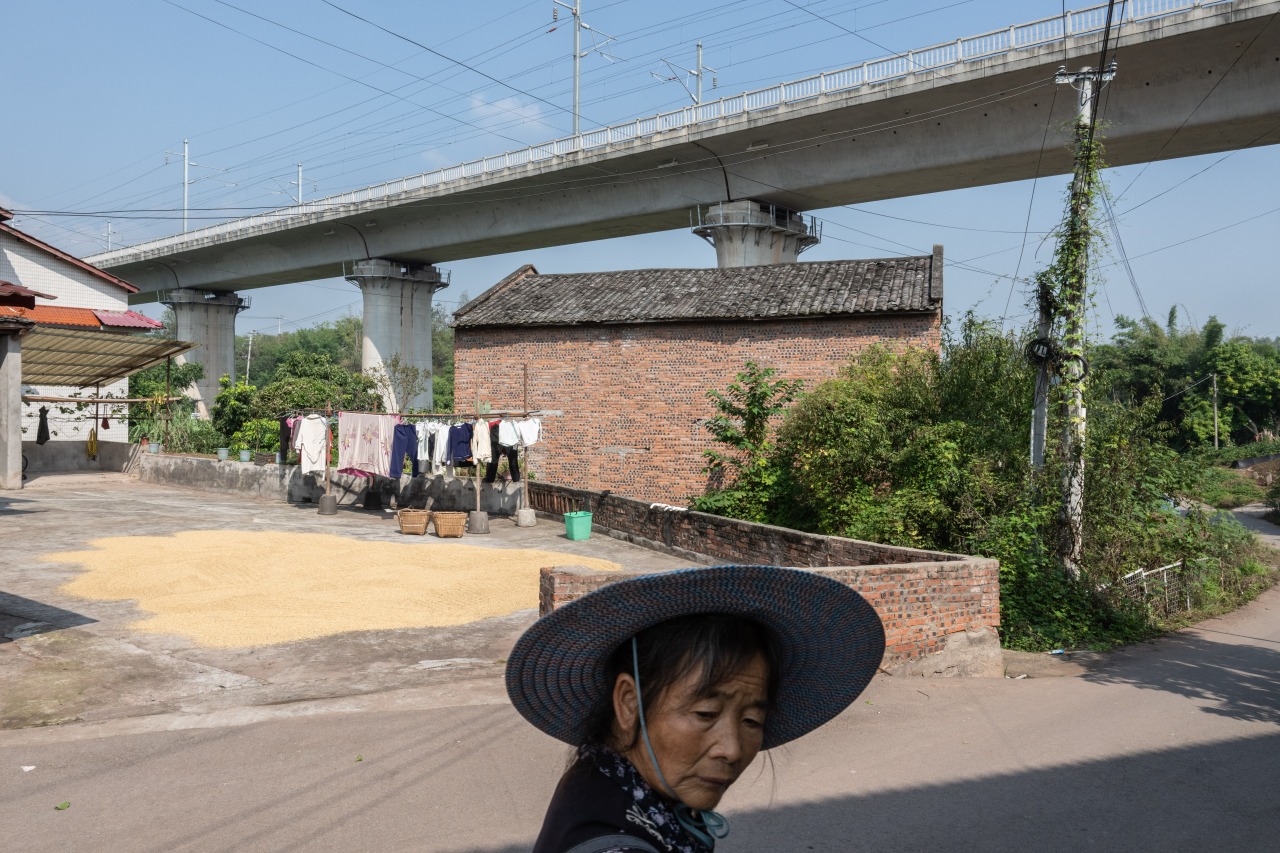 The tracks of a new railroad pass through a rural area near Fushun, China.